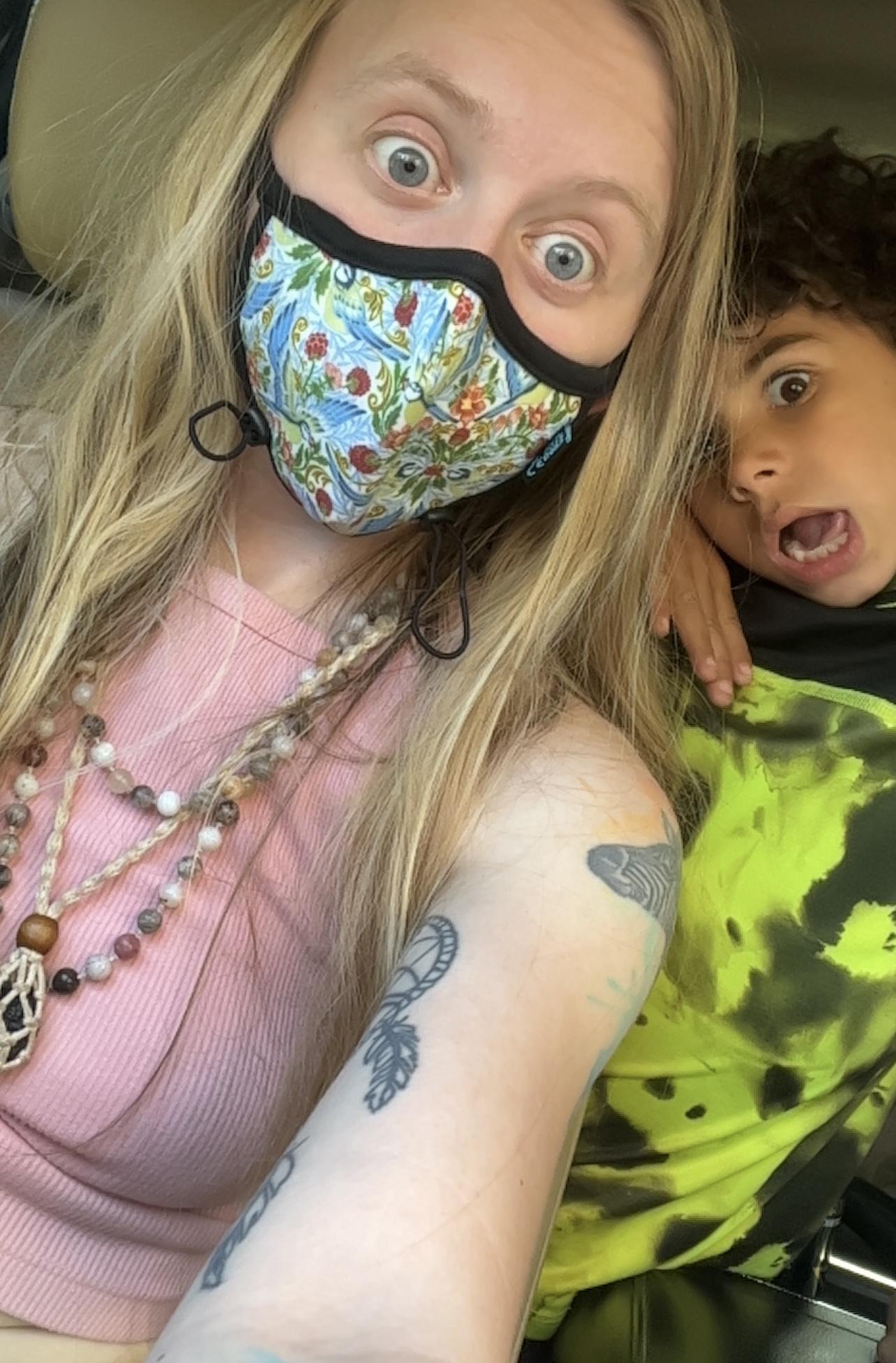 Ashley Clair wearing a patterned mask in a close-up selfie